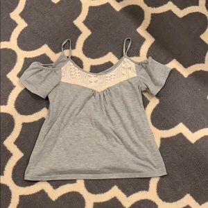 Gray t shirt with designs on it.
